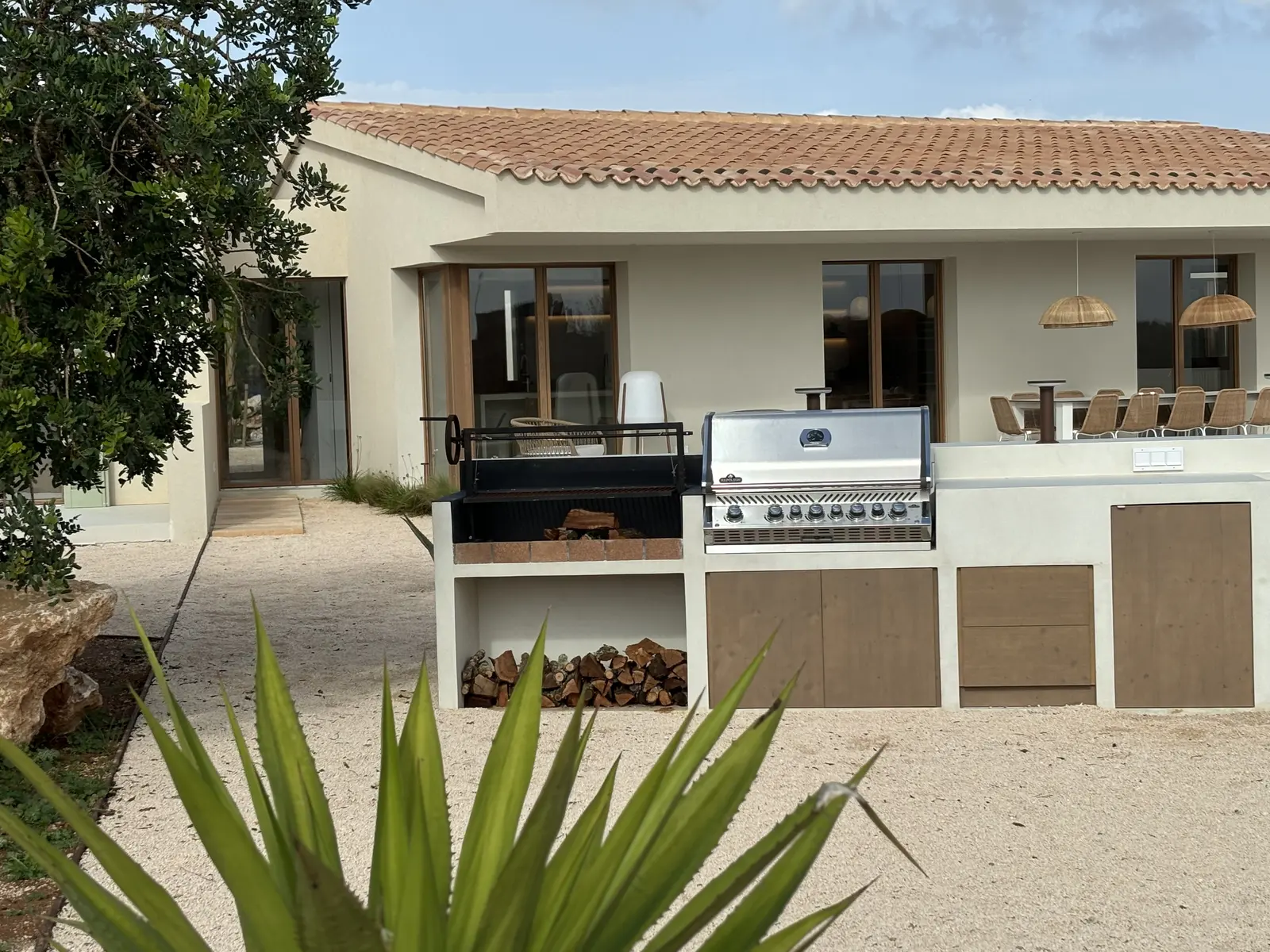 Outdoor kitchen with charcoal grill and terrace