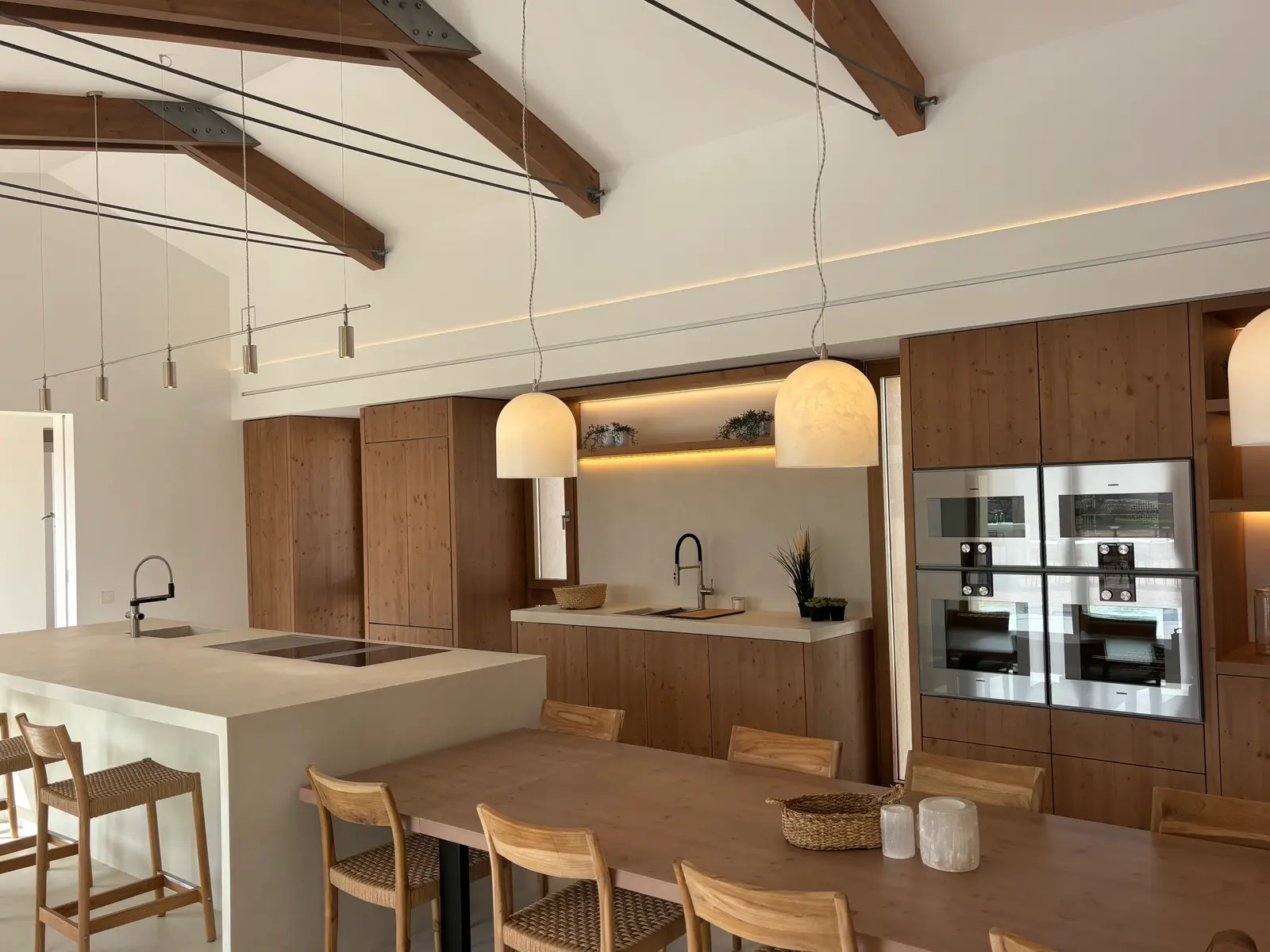 Open kitchen with island under timber beams