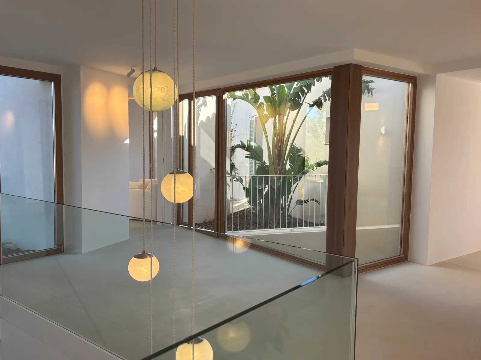 Gallery with glass balustrade and view into the courtyard