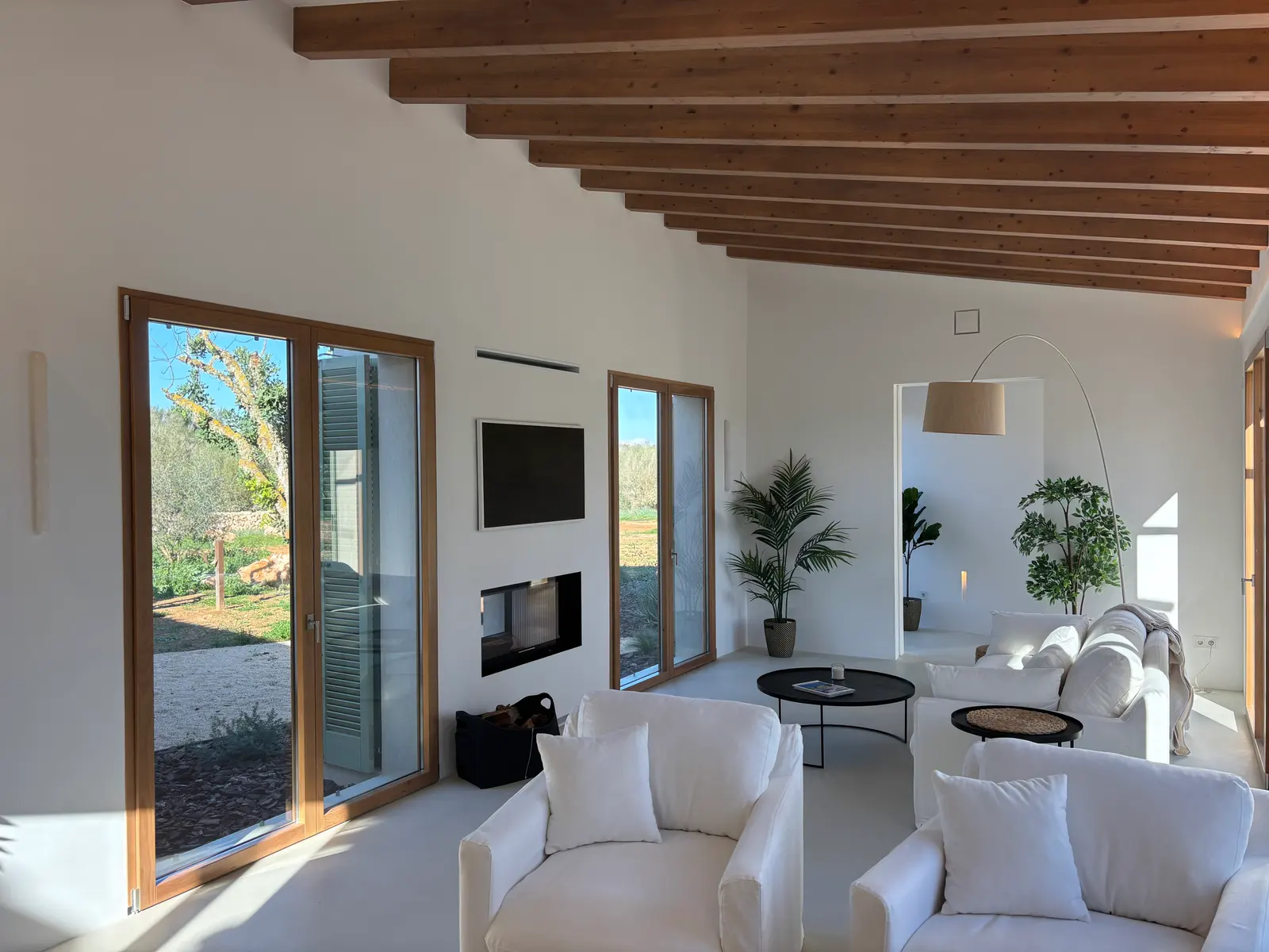 Living area with fireplace beneath open timber beams