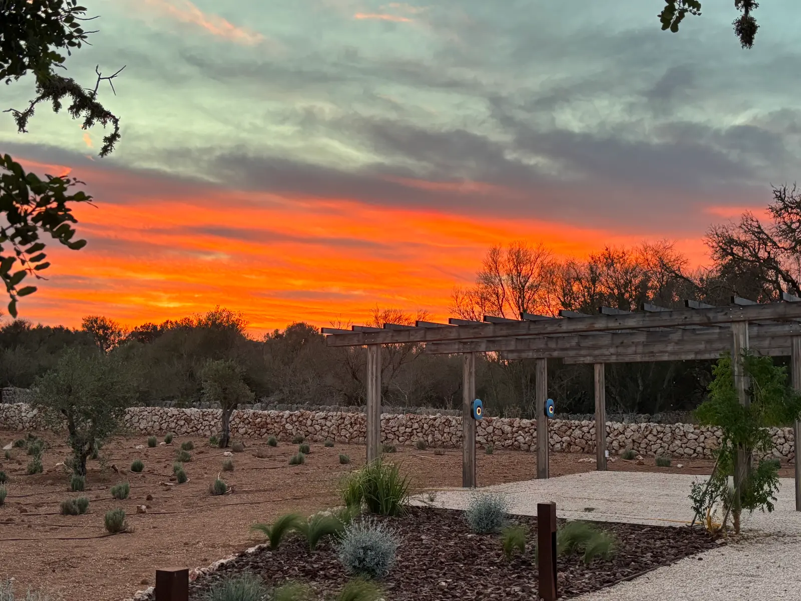 Pergola and dry-stone wall at sunset