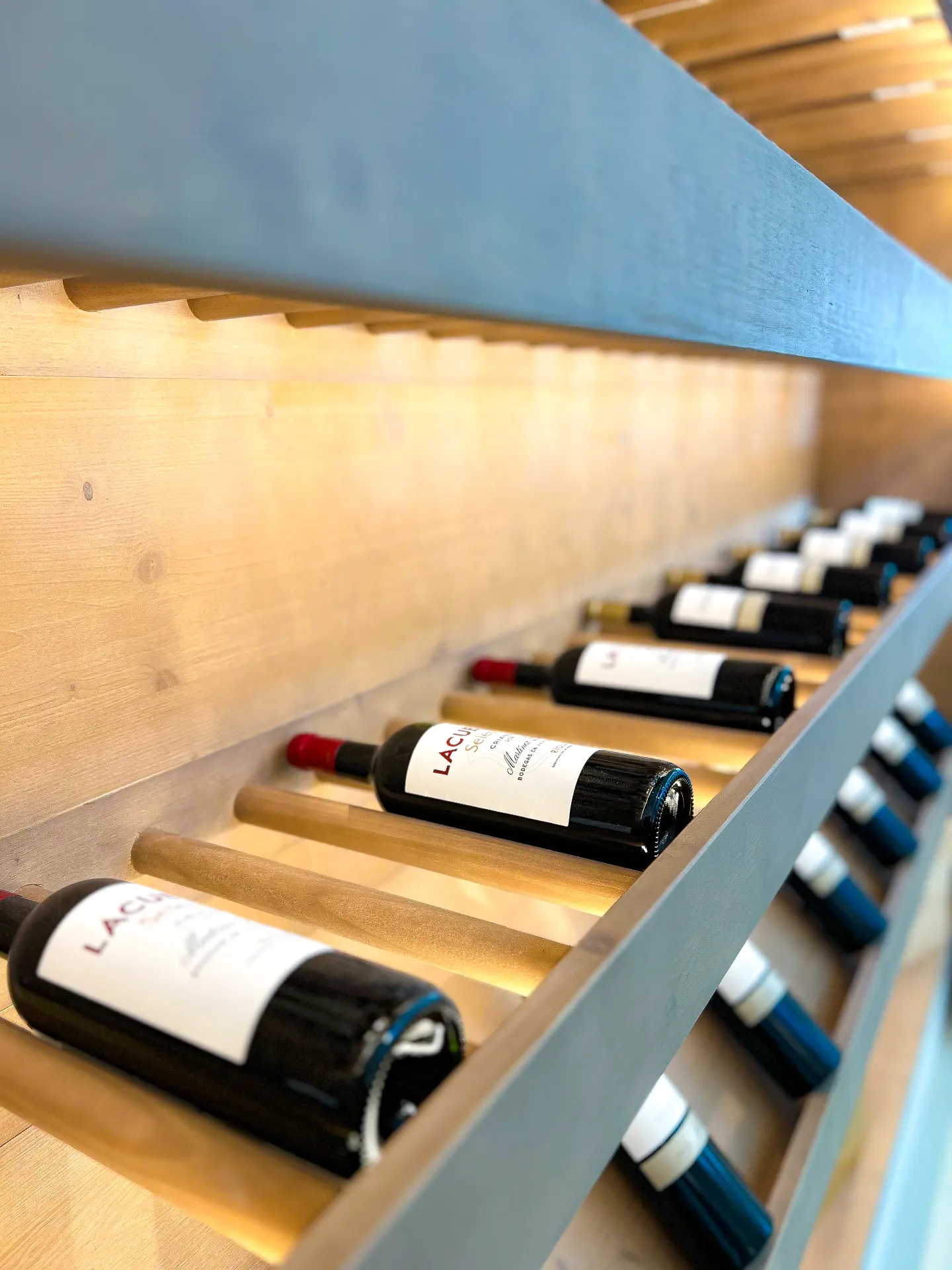 Illuminated wine cellar with timber bottle racks