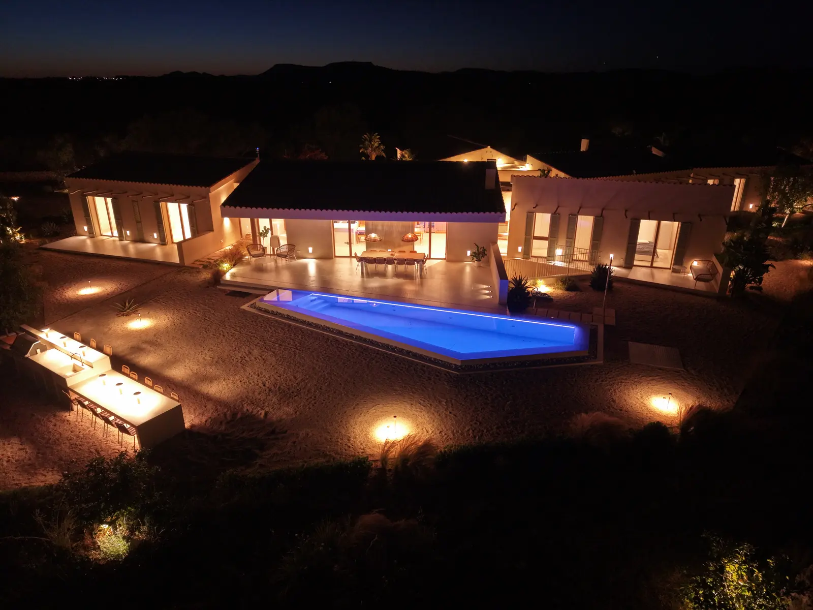A set table by the pool at night