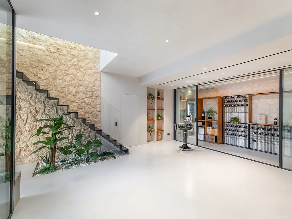 Living space with staircase and wine wall