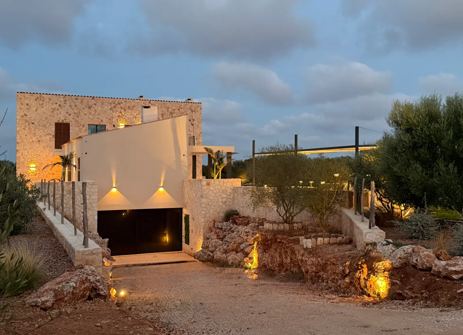 Illuminated approach with dry-stone walls in the evening