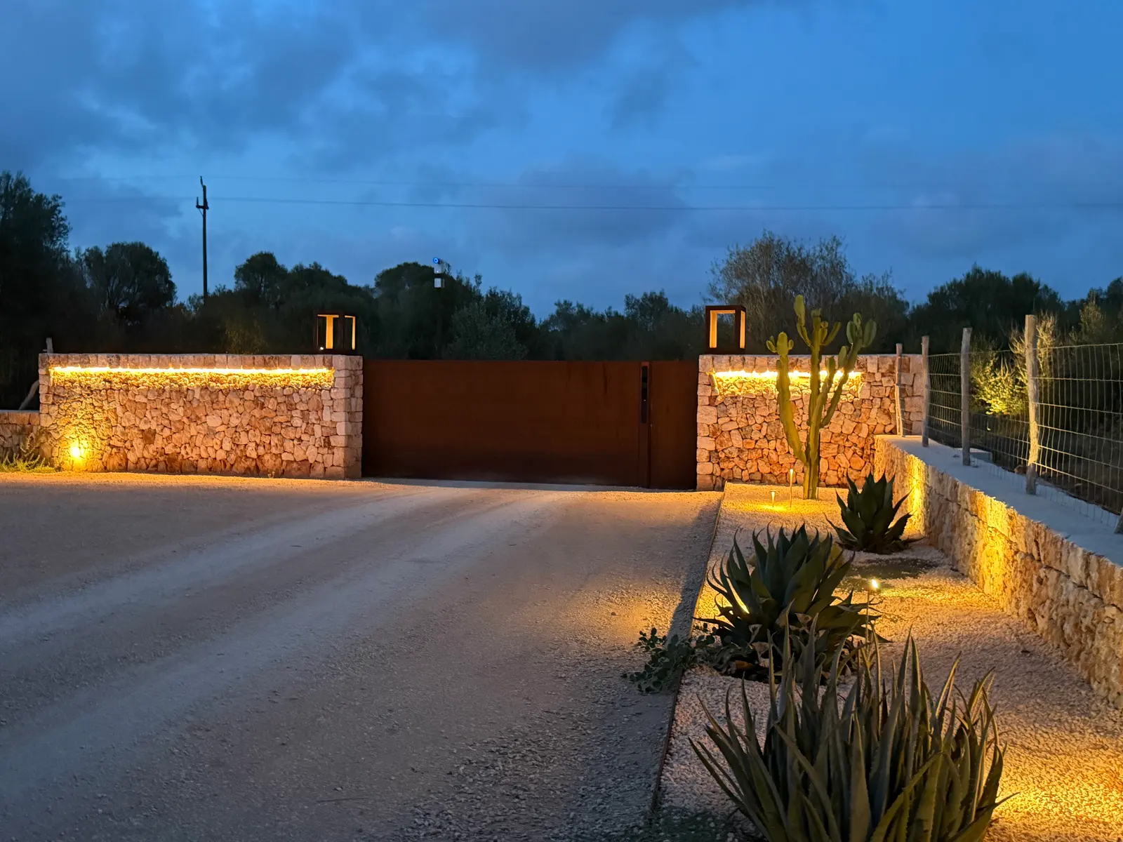Private Corten steel entrance gate at night