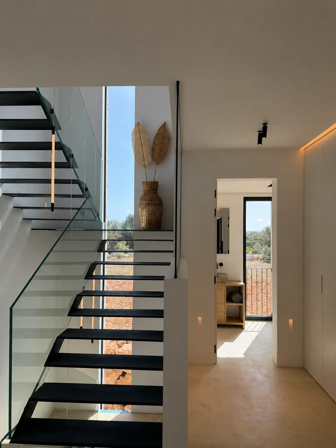 Staircase with glass balustrade and light slot
