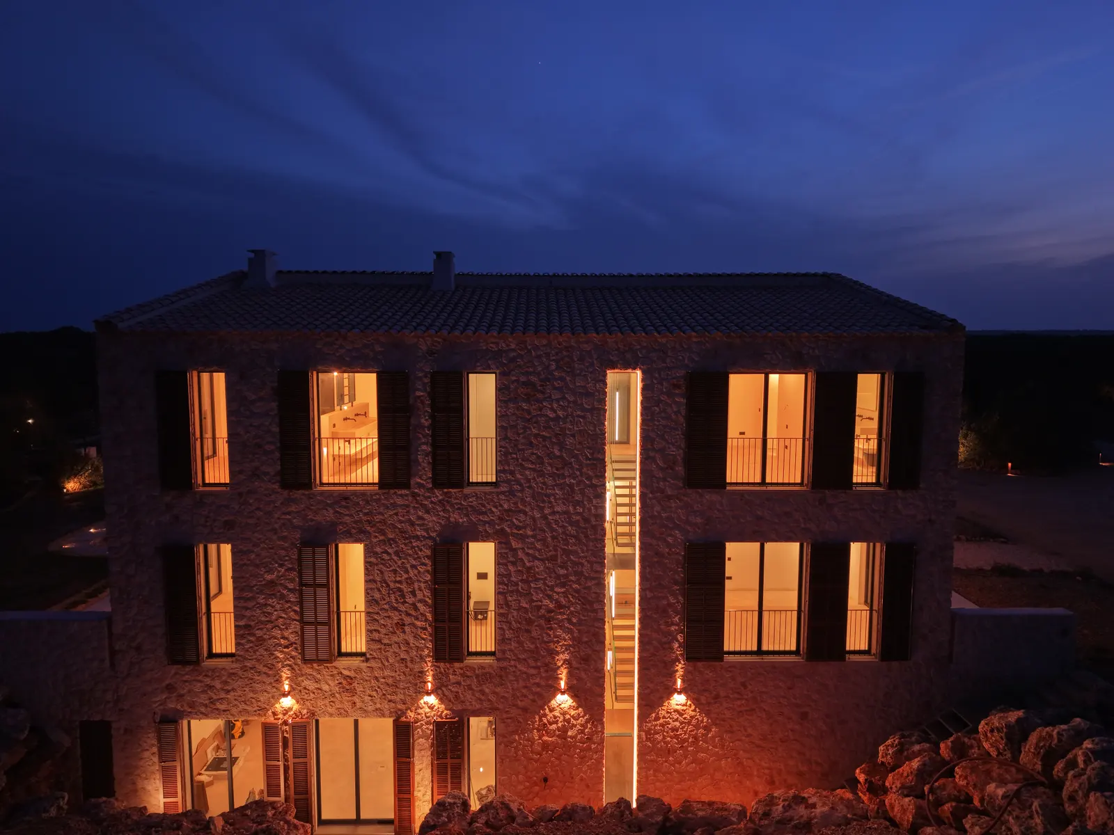 The stone facade glows at night