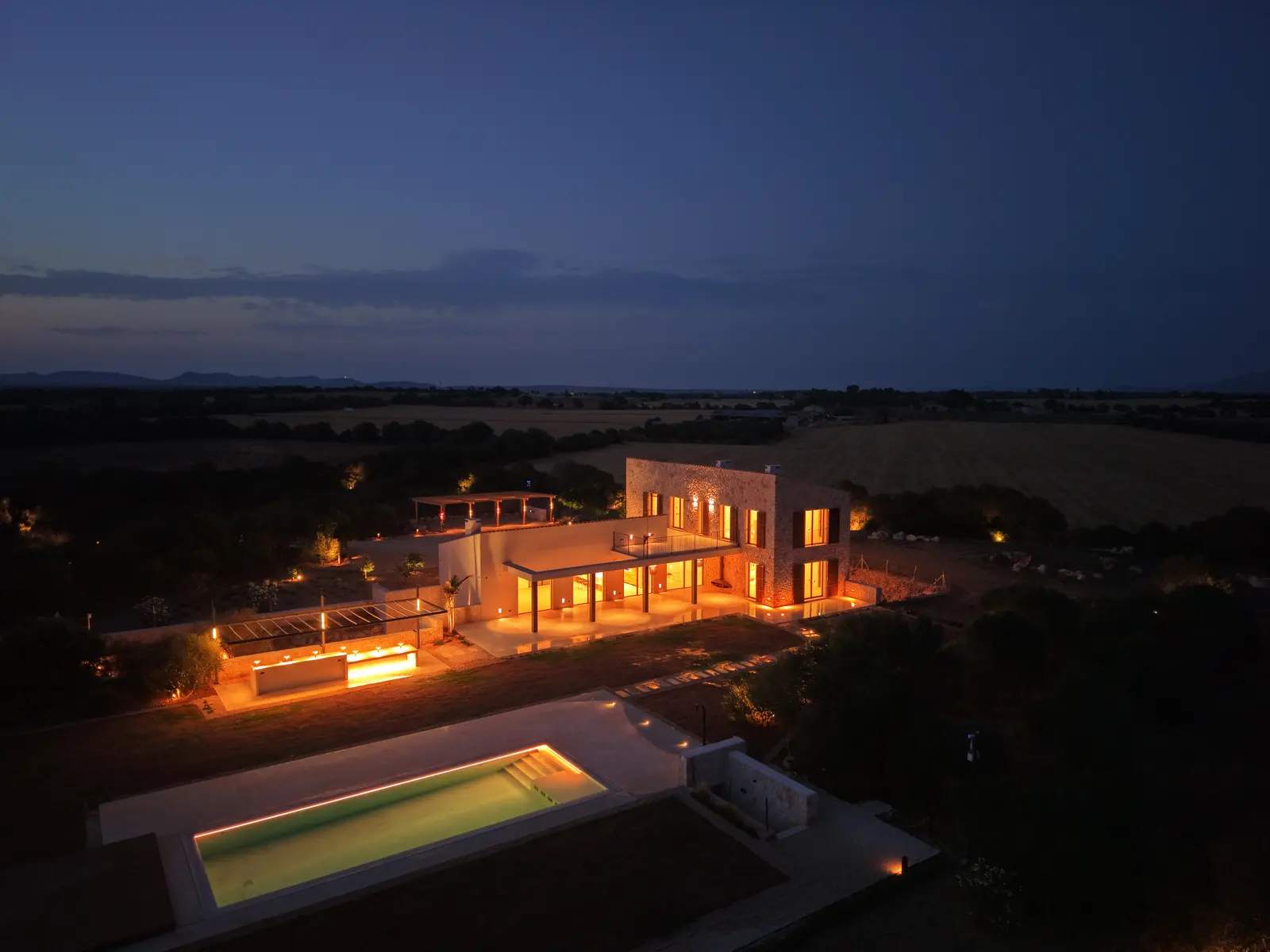 Pool and gardens at night from above